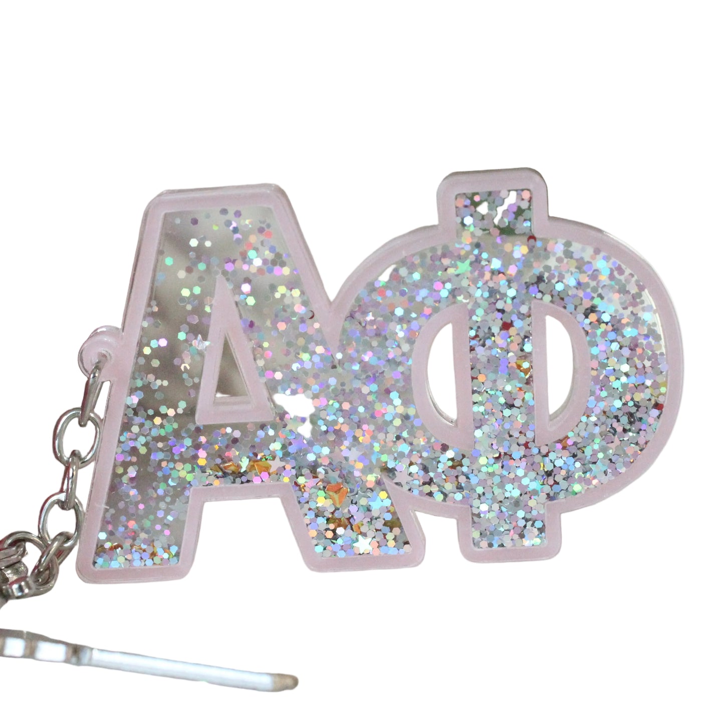 Keychain with glittery 'Alpha Phi' letters next to pink flowers and green leaves.
