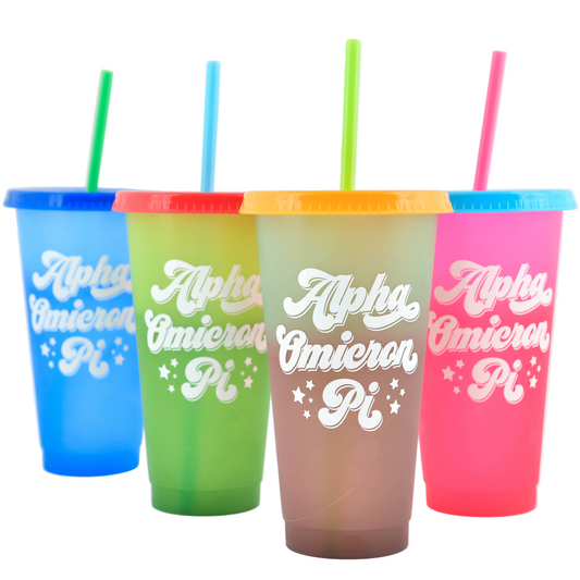 Four colorful tumblers with straws on a white background